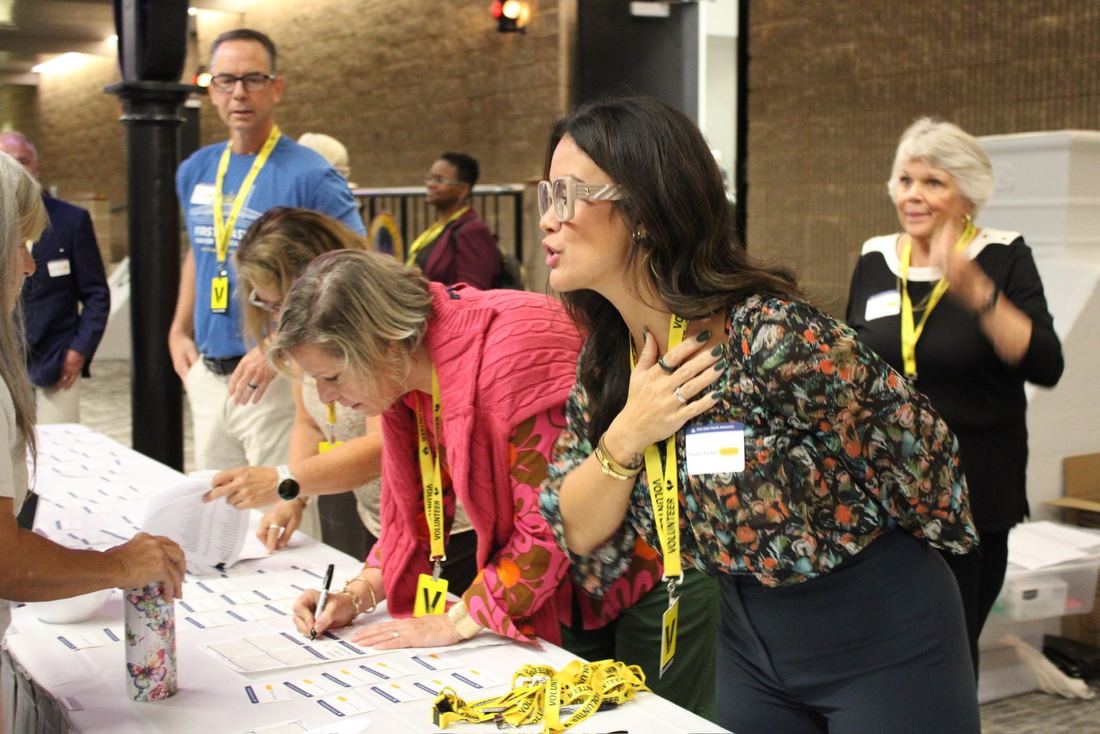 Volunteers laughing together at the registration table