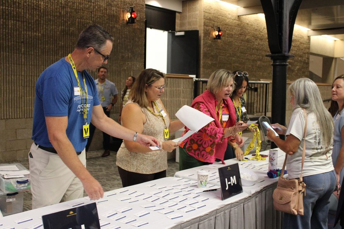 Volunteers handing out name badges at registration