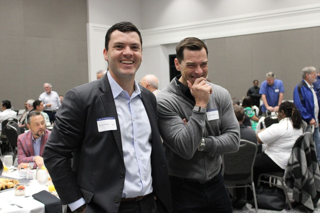 Two young men laughing in the ballroom