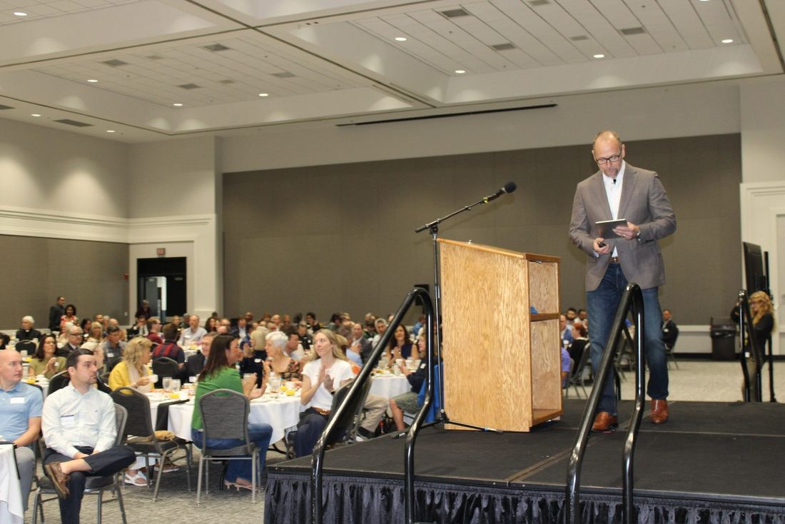 Matt McConnell welcoming guests from the stage