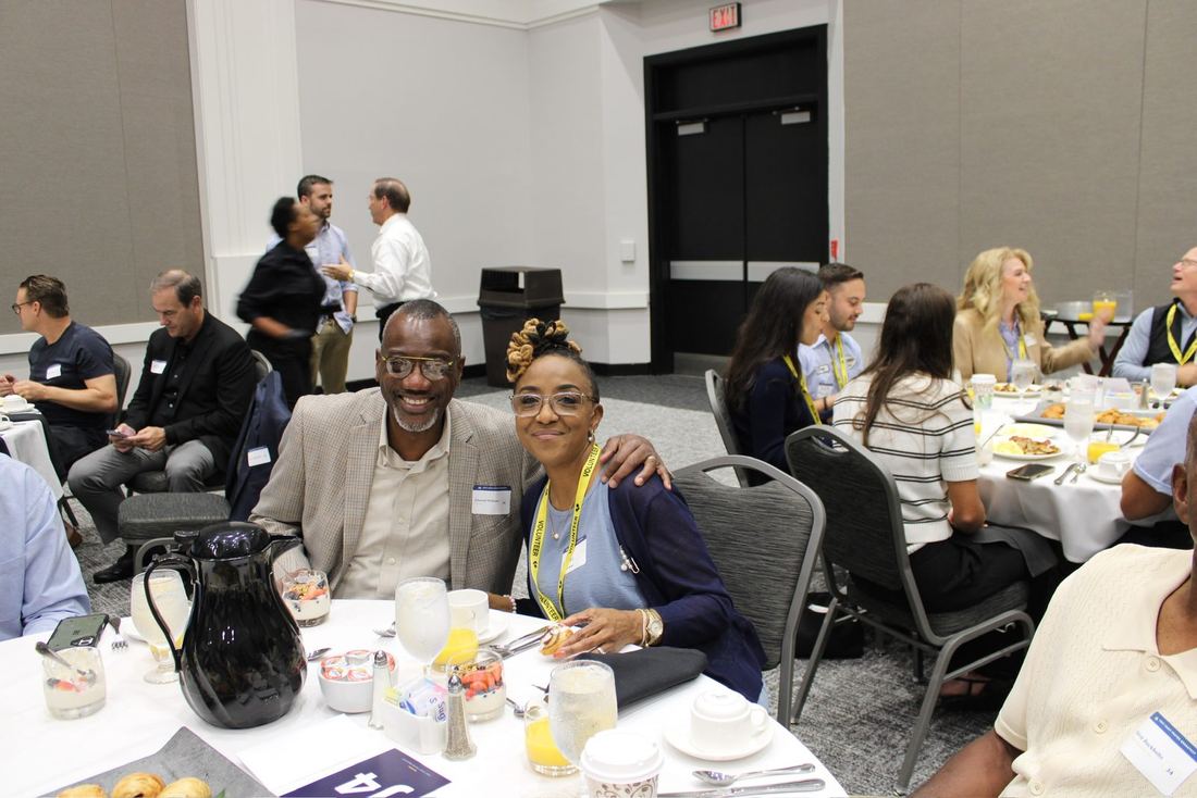 A couple smiling at their breakfast table