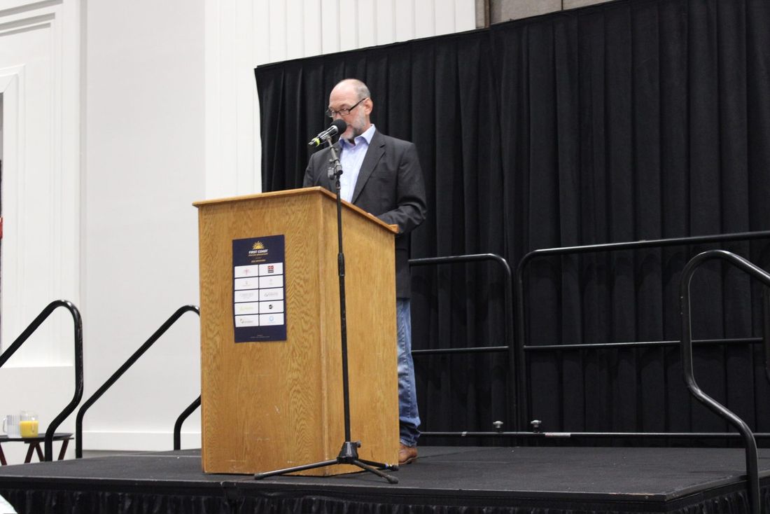 Scott Ryser speaking at the podium